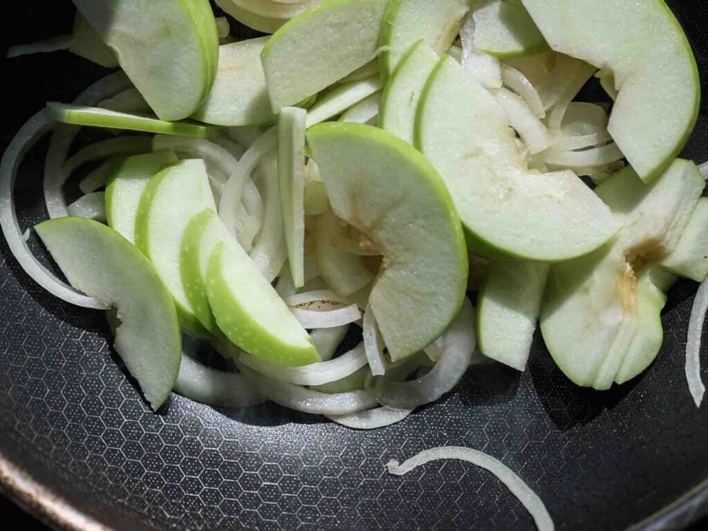 apples and onions in pan